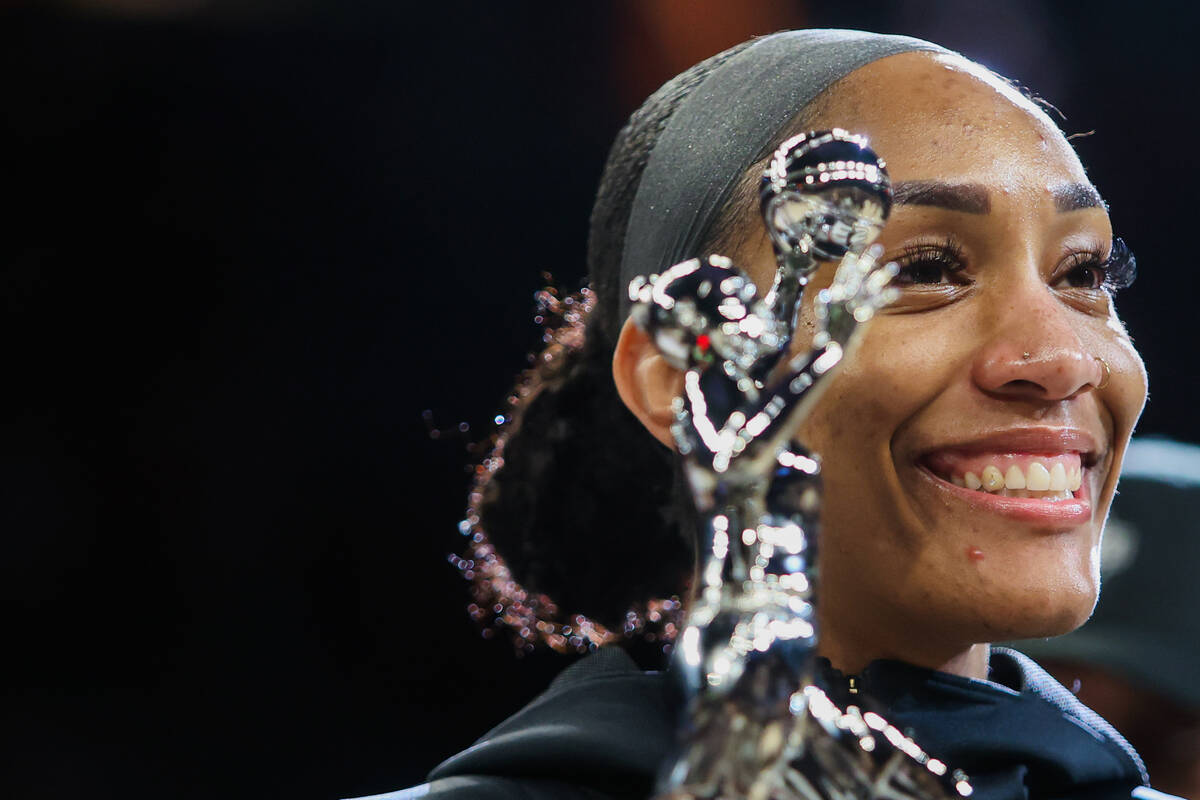 Aces center A'ja Wilson holds up her WNBA MVP trophy before game one of a WNBA playoff game bet ...