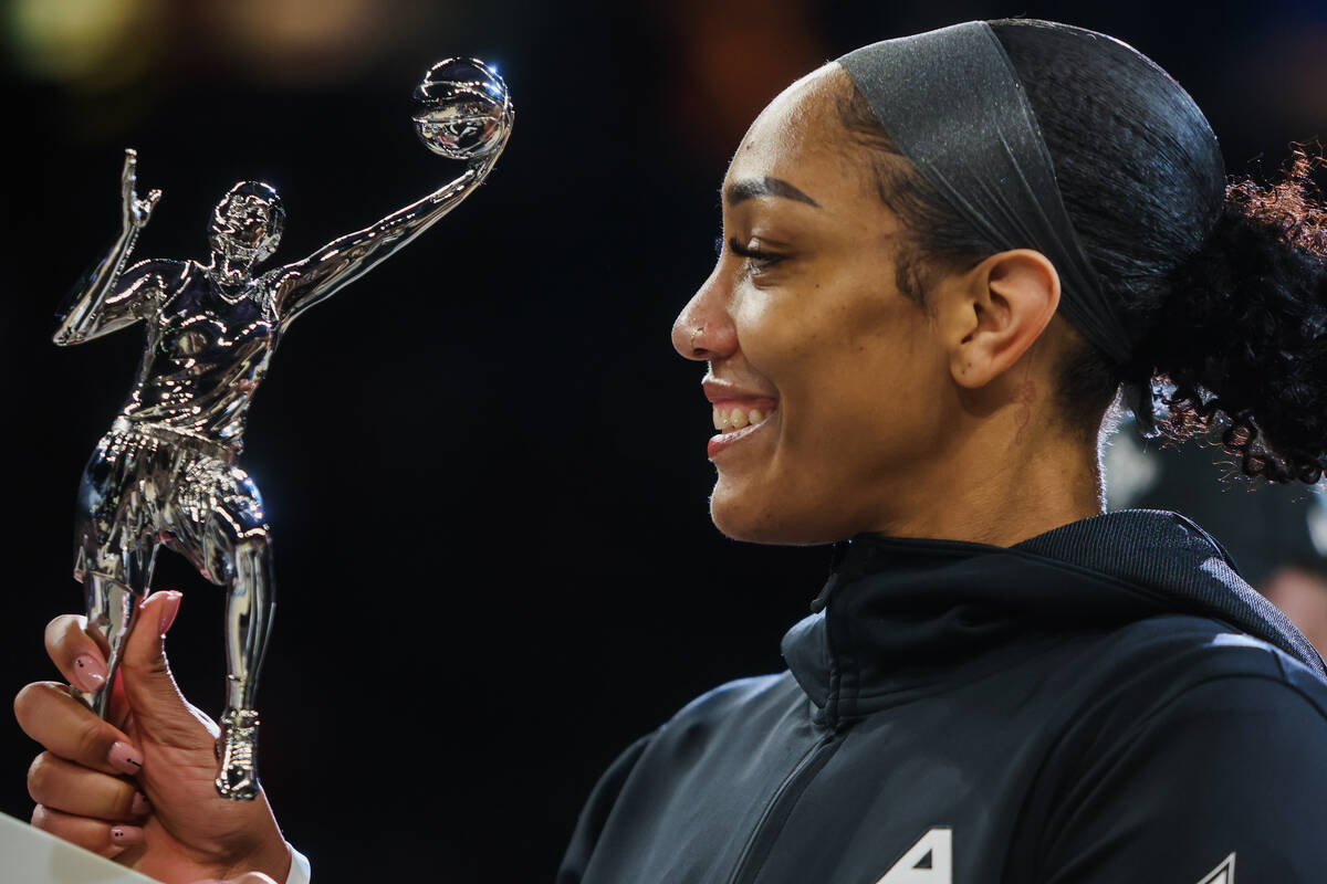 Aces center A'ja Wilson holds up her WNBA MVP trophy before game one of a WNBA playoff game bet ...