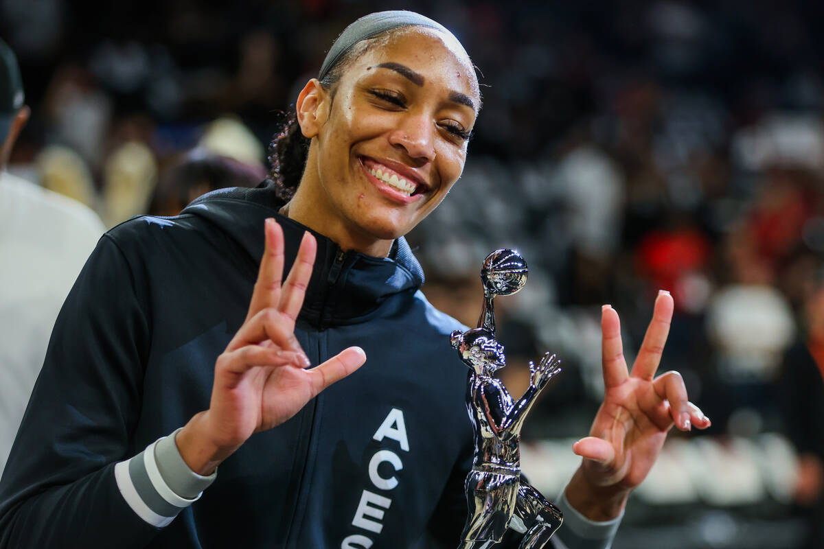 Aces center A'ja Wilson poses with her WNBA MVP trophy before game one of a WNBA playoff game b ...