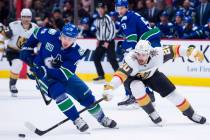 Vancouver Canucks left wing Tanner Pearson (70) vies for control of the puck with Vegas Golden ...