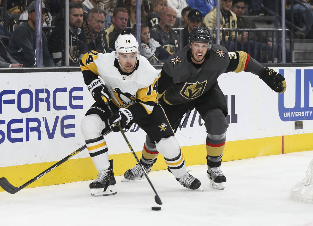 Pittsburgh Penguins left wing Tanner Pearson (14) moves the puck in front of Golden Knights def ...