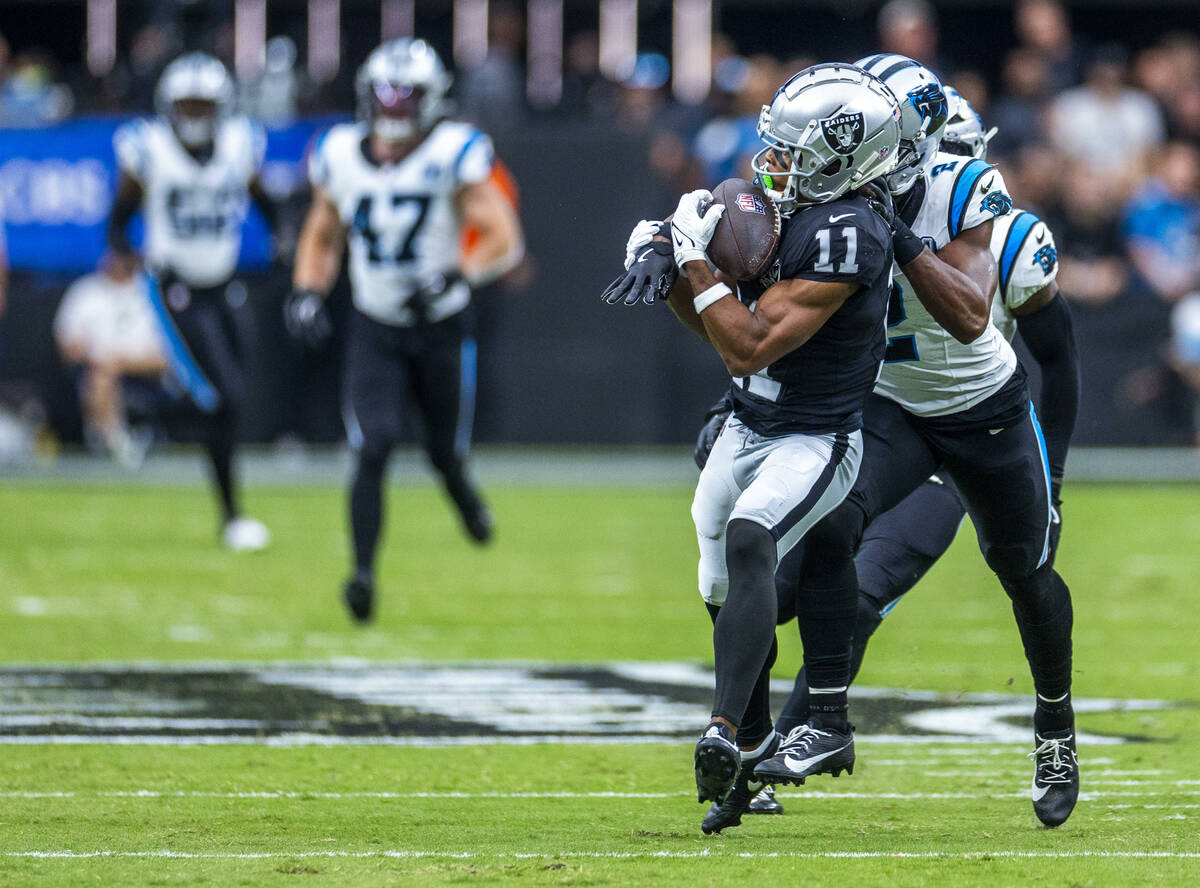 Raiders wide receiver Tre Tucker (11) looks in a long pass over Carolina Panthers cornerback Mi ...