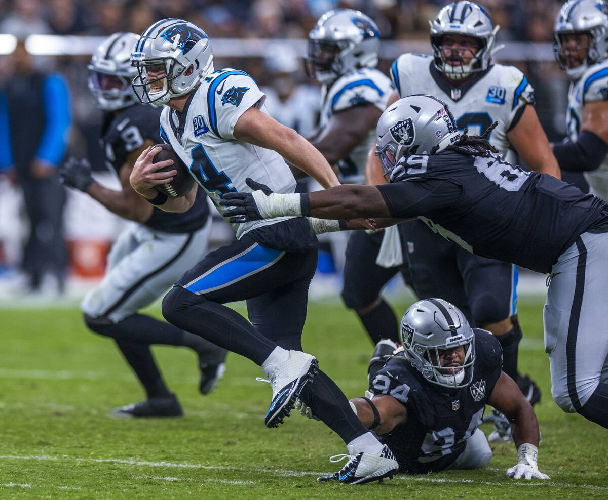 Carolina Panthers quarterback Andy Dalton (14) breaks free for a run as Raiders defensive tackl ...