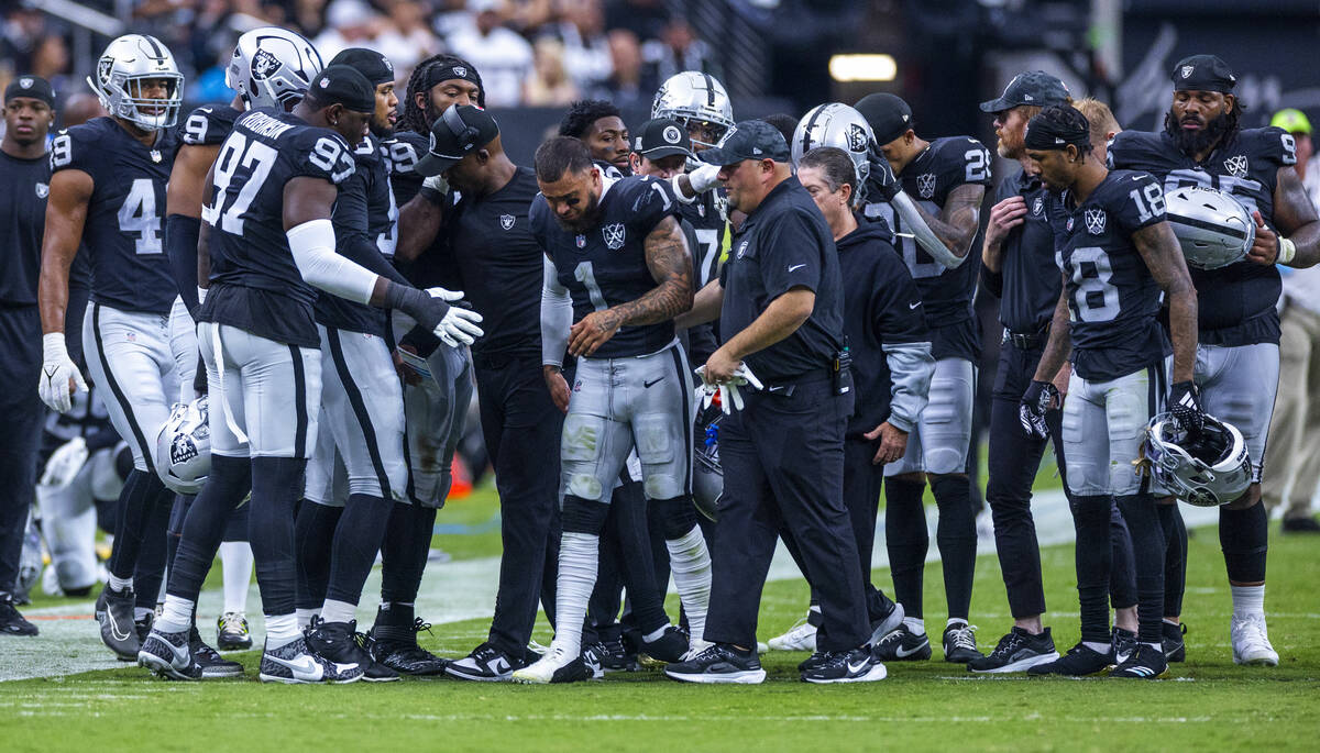 Raiders safety Marcus Epps (1) is assisted off the field with a possible knee injury against th ...