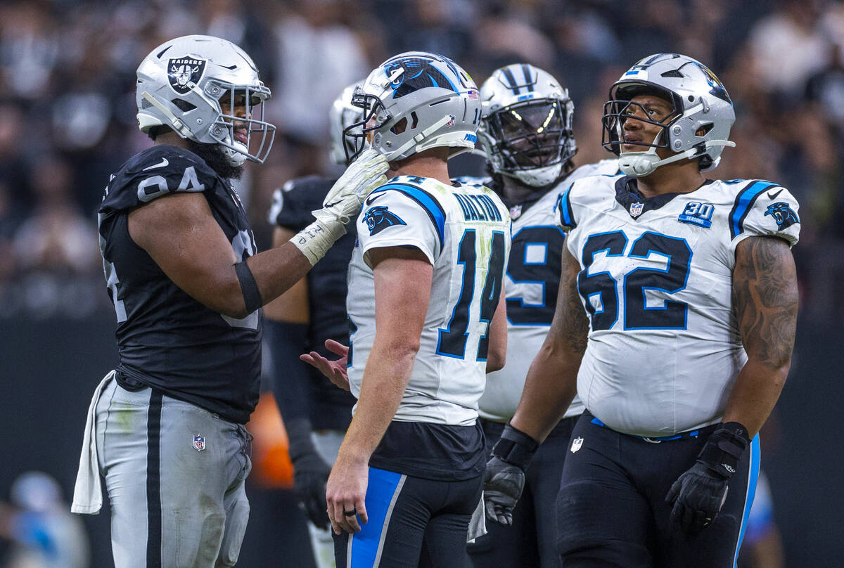 Raiders defensive tackle Christian Wilkins (94) talks with Carolina Panthers quarterback Andy D ...