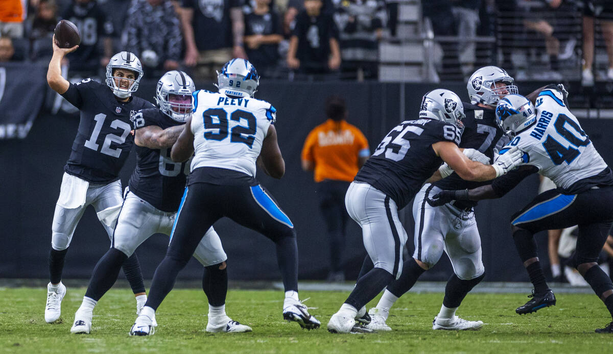 Raiders quarterback Aidan O'Connell (12) throws a late pass against the Carolina Panthers durin ...