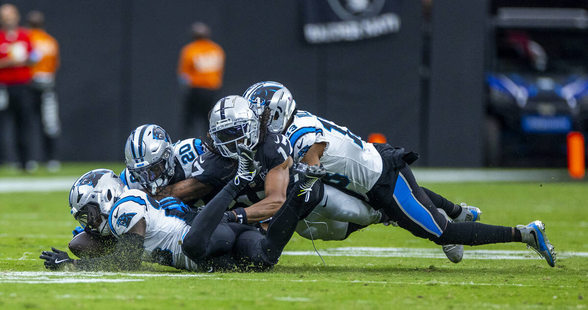 Raiders wide receiver Davante Adams (17) is swarmed by Carolina Panthers after an incomplete pa ...