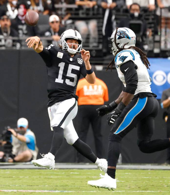 Raiders quarterback Gardner Minshew (15) throws under pressure from Carolina Panthers linebacke ...