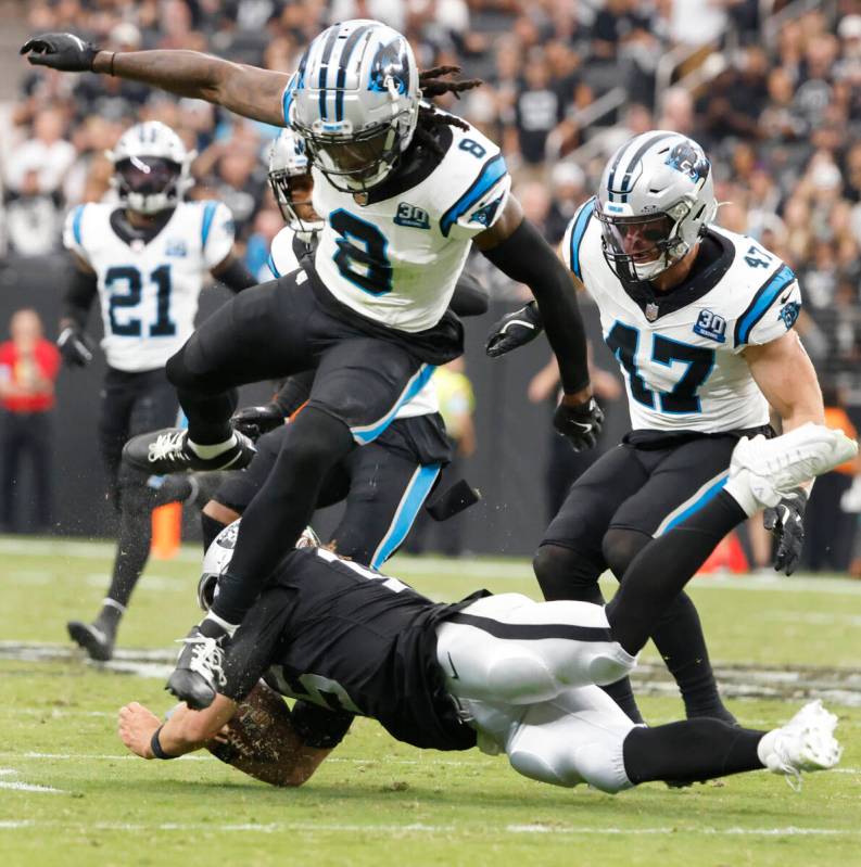 Carolina Panthers cornerback Jaycee Horn (8) leaps over Raiders quarterback Gardner Minshew (15 ...