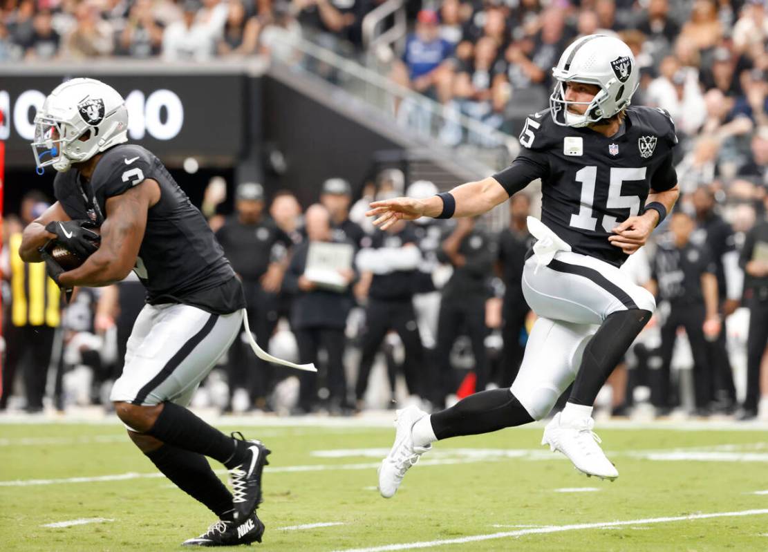 Raiders quarterback Gardner Minshew (15) hands off to running back Zamir White (3) during the f ...