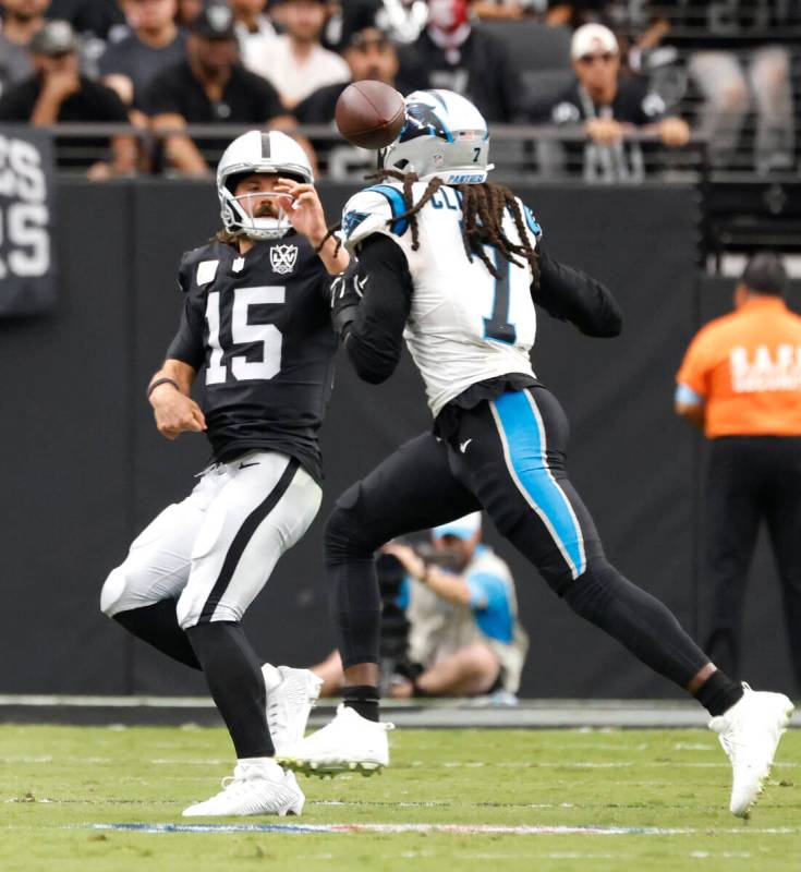 Raiders quarterback Gardner Minshew (15) throws under pressure from Carolina Panthers linebacke ...