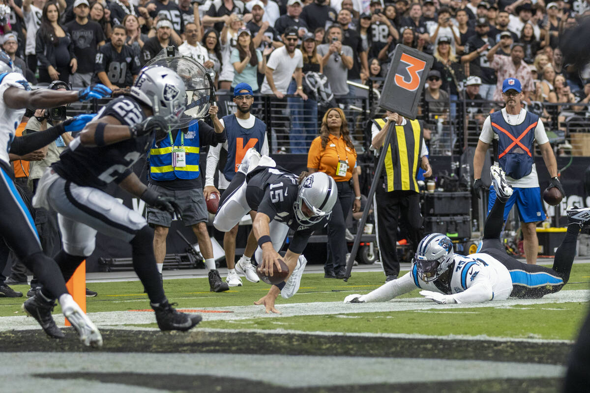 Raiders quarterback Gardner Minshew (15) extends himself for a first down with Carolina Panthe ...