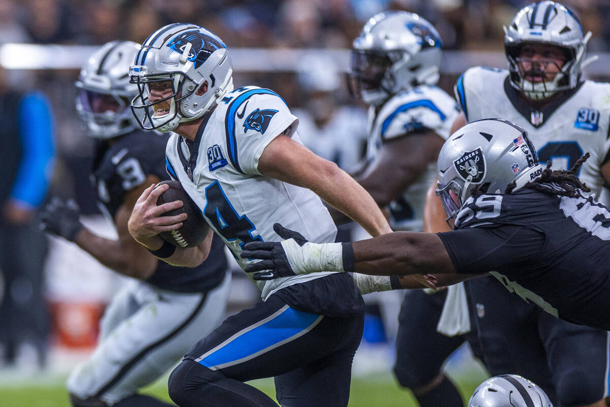 Carolina Panthers quarterback Andy Dalton (14) breaks free for a run as Raiders defensive tackl ...