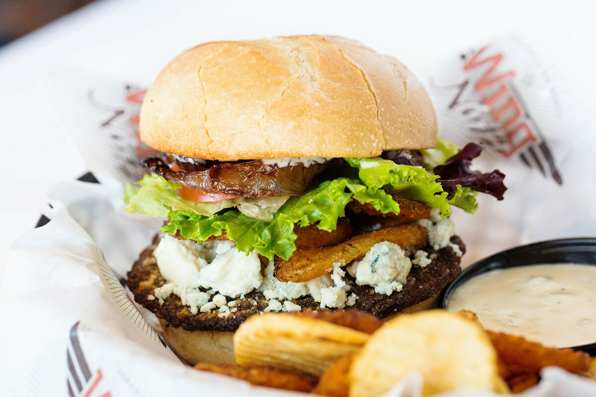 A Buffalo Bleu Burger, with blue cheese crumbles, baked spicy buffalo chips and spicy blue chee ...