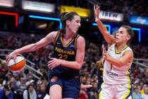 Indiana Fever guard Caitlin Clark (22) makes a behind the back pass in front of Dallas Wings gu ...