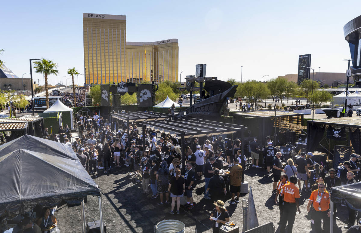 Fans enjoy food, drinks, games and more in the new Raiders Pregame Masqueraid venue in the tail ...