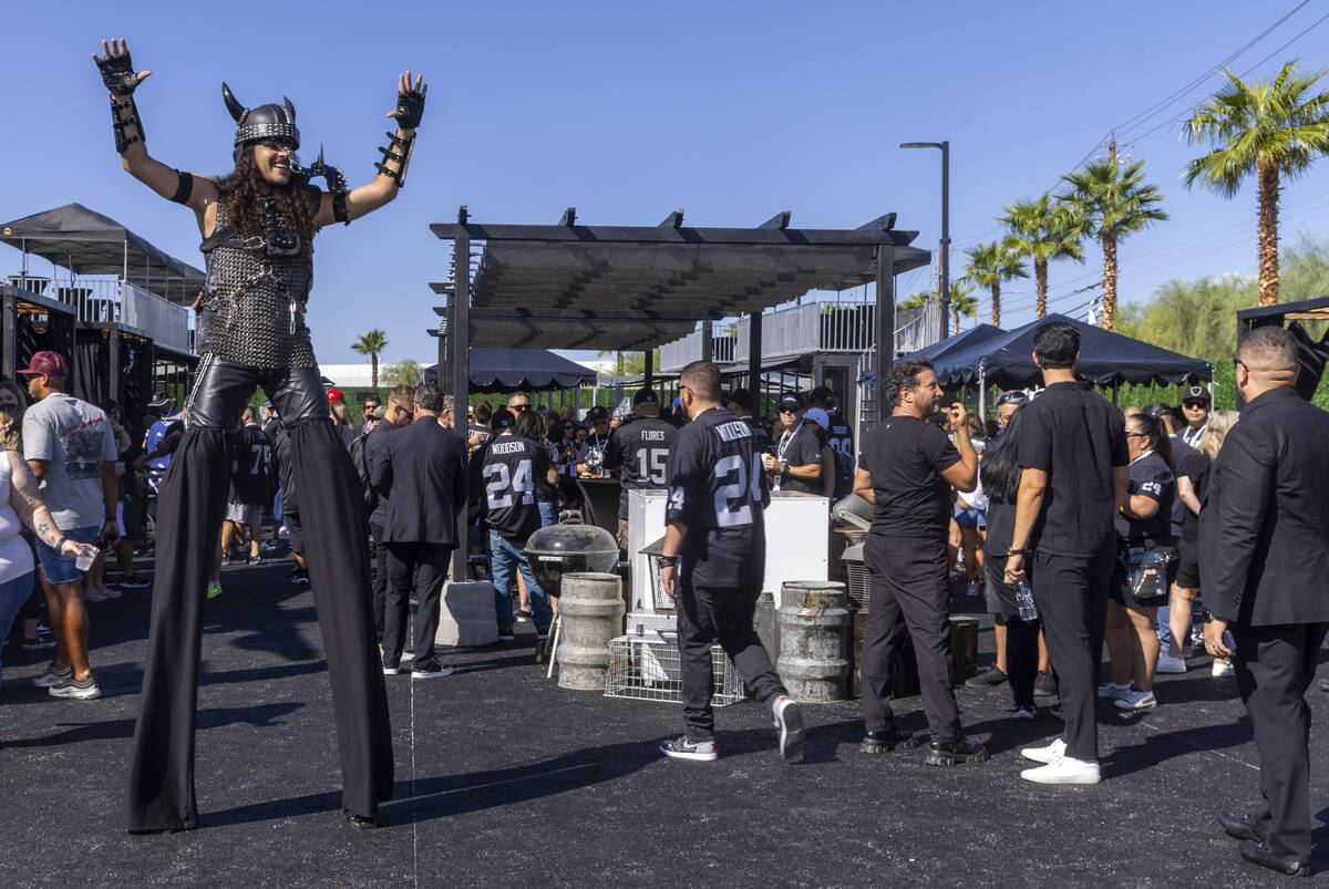 A performer entertains the fans in the new Raiders Pregame Masqueraid venue in the tailgate bef ...