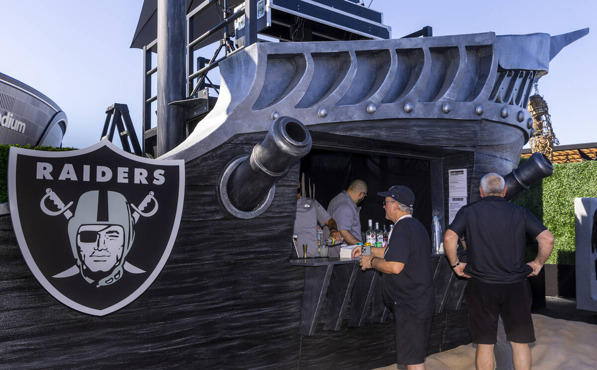 Fans step up the a pirate ship bar in the new Raiders Pregame Masqueraid venue in the tailgate ...