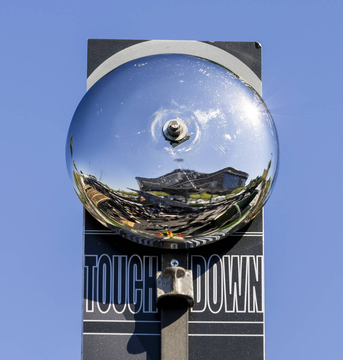 A fan rings the bell in a High Striker game in the new Raiders Pregame Masqueraid venue in the ...