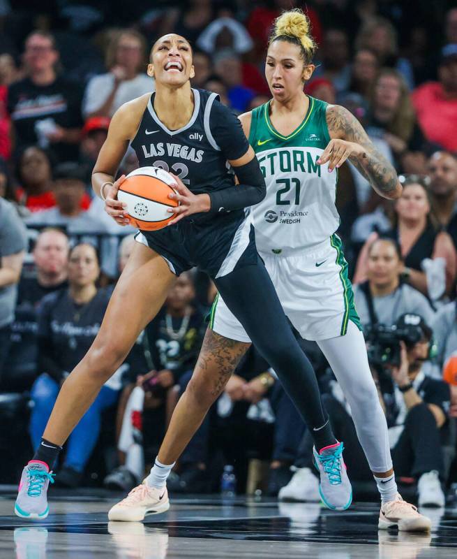 Aces center A'ja Wilson (22) struggles to find an opening to shoot the ball as Seattle Storm ce ...