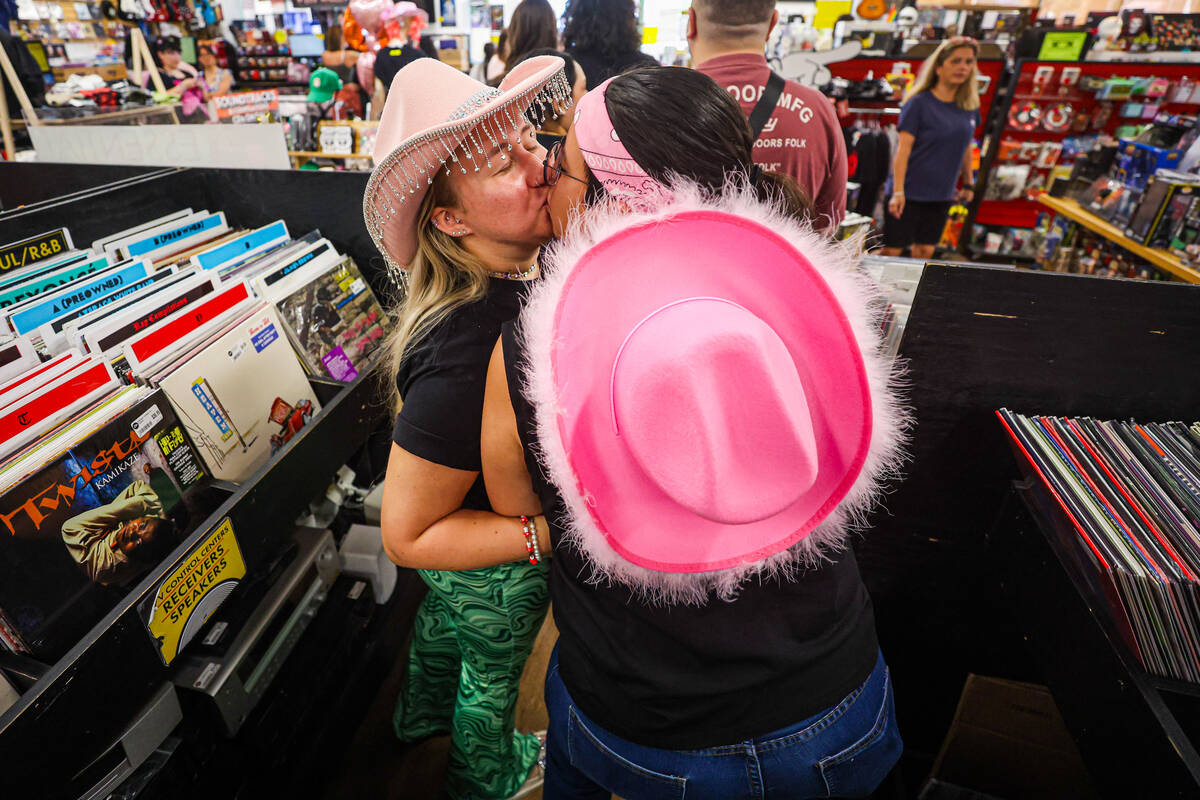 Darrah Westbay, left, kisses Karina Vega, during a listening party in honor of the one year ann ...