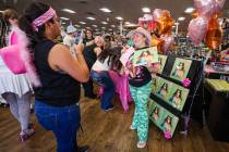 Karina Vega, left, takes a photograph of Darrah Westbay, right, during a listening party in hon ...