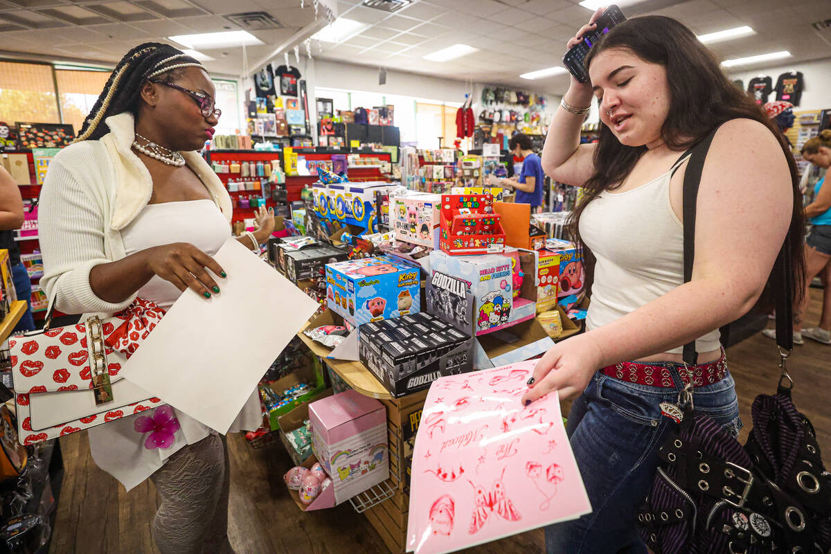 Chappell Roan fans Ebonique Butler, left, and Irelynn Frais dance during a listening party in h ...