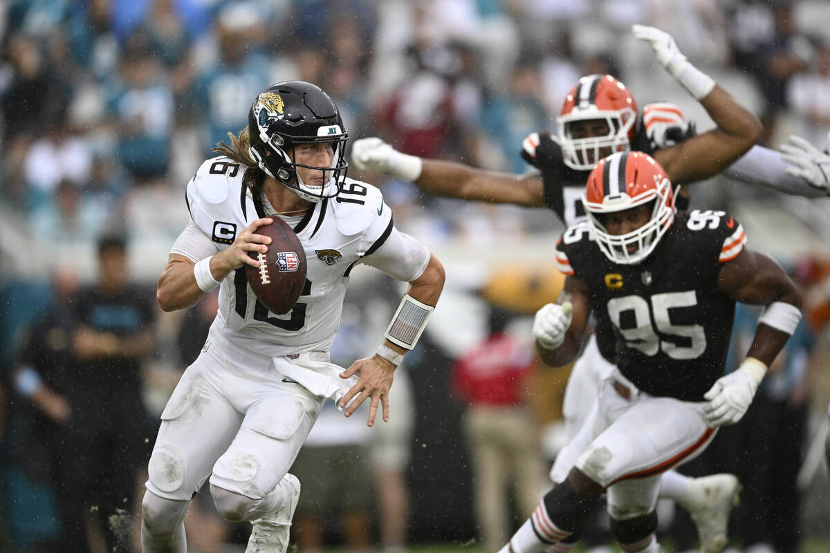 Jacksonville Jaguars quarterback Trevor Lawrence (16) scrambles for yardage as Cleveland Browns ...