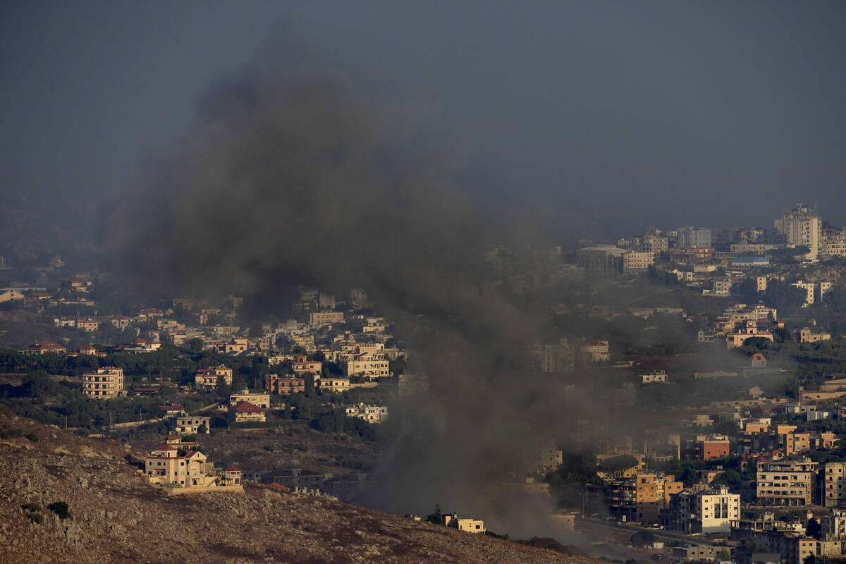 Smoke rises from an Israeli airstrike on Kfar Rouman village, as seen from Marjayoun town, sout ...