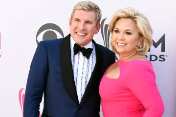 Todd Chrisley, left, and his wife, Julie Chrisley, pose for photos at the 52nd annual Academy o ...