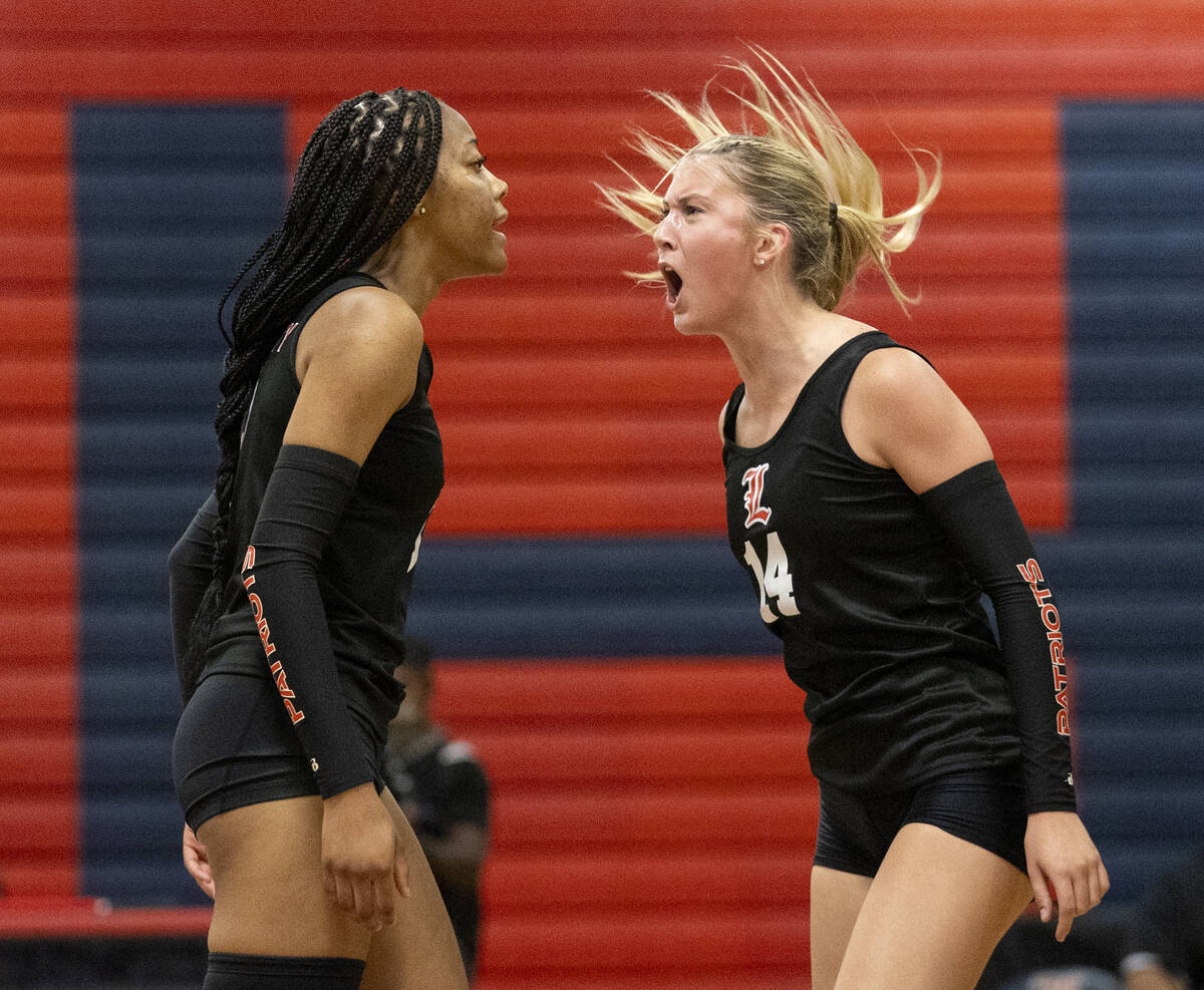 Liberty sophomore Addison Jones (14) and Liberty senior Kennedy Cooper (3) celebrate after a bl ...