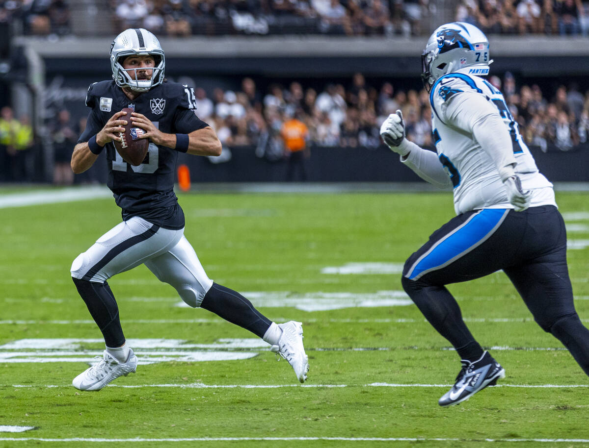 Raiders quarterback Gardner Minshew (15) scrambles on a run against Carolina Panthers defensive ...