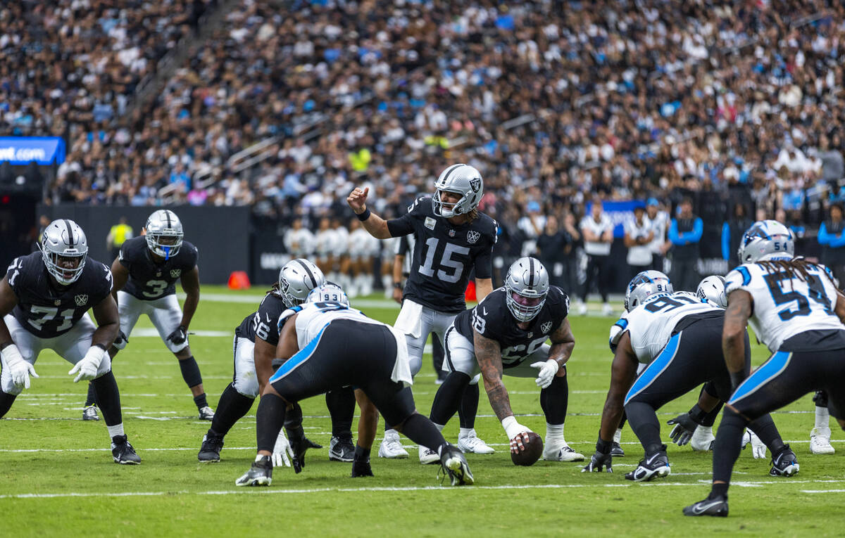 Raiders quarterback Gardner Minshew (15) makes an adjustment during the first half of their NFL ...