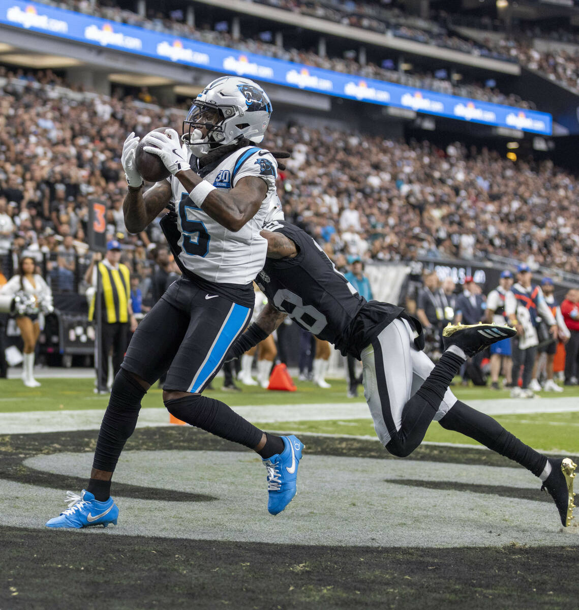 Carolina Panthers wide receiver Diontae Johnson (5) scores over Raiders cornerback Jack Jones ( ...