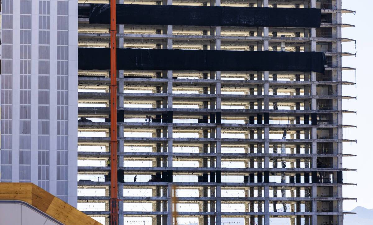 A worker walks along a floor of the rear tower as preparations for the upcoming implosion conti ...