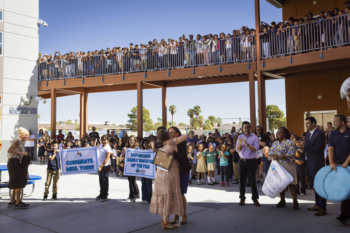 Pre-K teacher Leigh Todd of Tate Elementary School gets a hug from Nevada Department of Educati ...