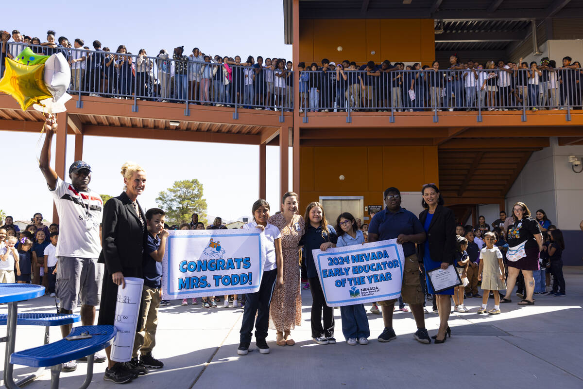 Pre-K teacher Leigh Todd, center, of Tate Elementary School poses for photos after being named ...