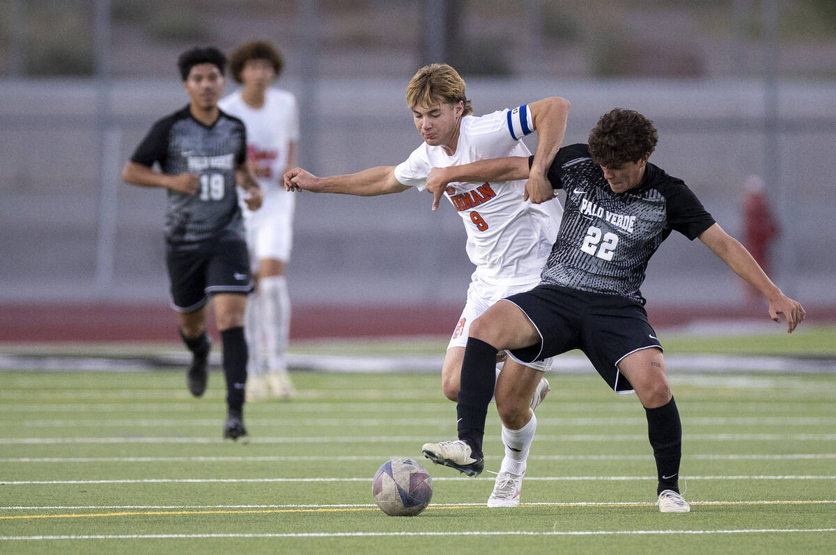 Bishop Gorman forward Chase Stewart (9) and Palo Verde midfielder Trustin Parker (22) compete f ...