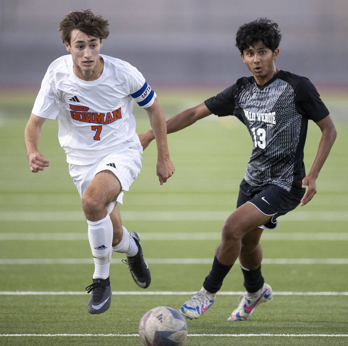 Bishop Gorman midfielder Maddix Bordinhao (7) and Palo Verde sophomore Haydn Rodrigues (13) run ...