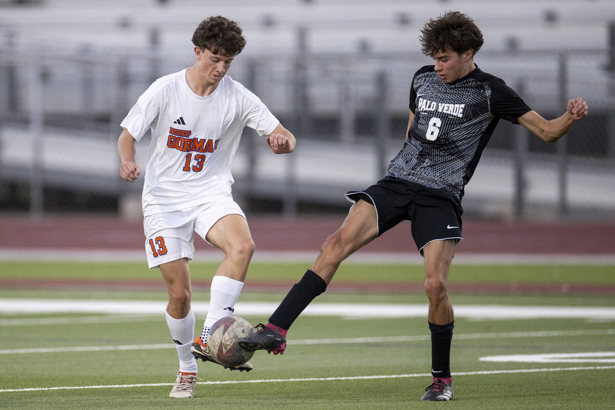 Bishop Gorman defender Maxim Mundson (13) and Palo Verde senior Cruz Carranza (6) compete for t ...