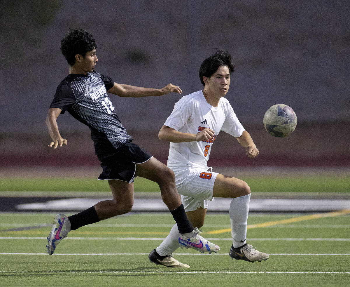 Palo Verde sophomore Haydn Rodrigues (13) and Bishop Gorman midfielder Rockwell Rabago (8) comp ...