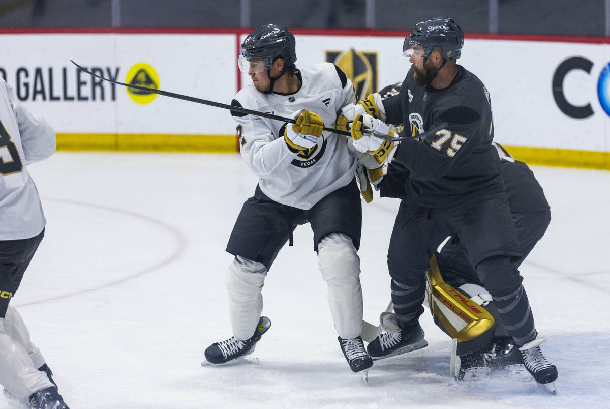 Golden Knights defenseman Zach Whitecloud (2) battles for position with forward Mitch McLain ( ...