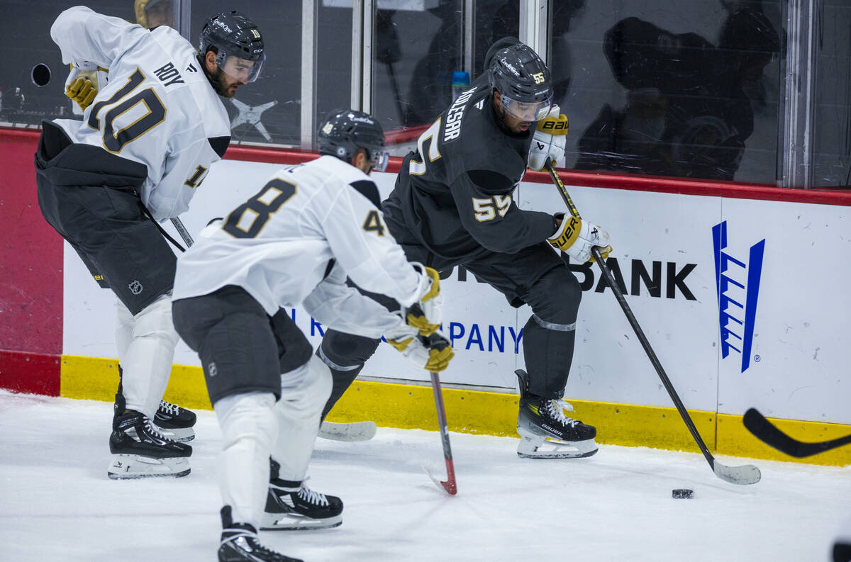 Golden Knights right wing Keegan Kolesar (55) controls the puck against center Tomas Hertl (48) ...