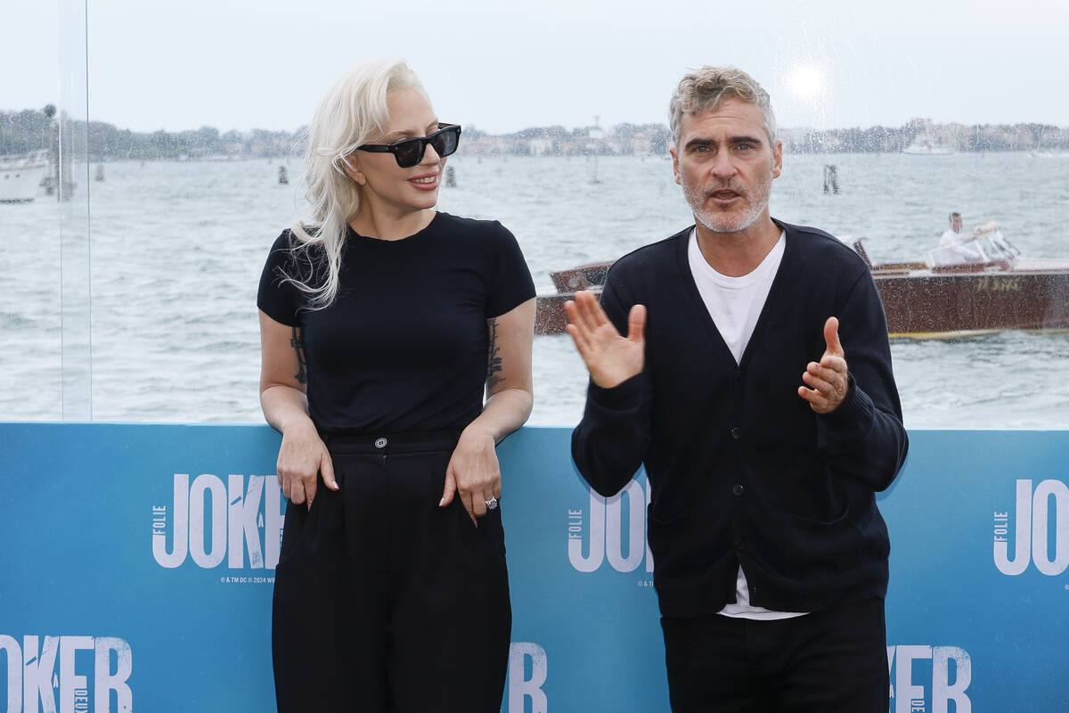 Lady Gaga, left, and Joaquin Phoenix pose for photographers at the photo call for the film 'Jok ...