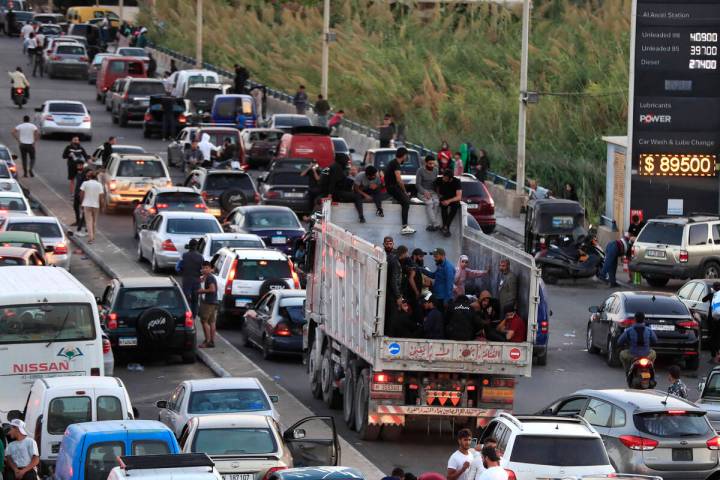 Lebanese citizens who fled on the southern villages amid ongoing Israeli airstrikes Monday, sit ...