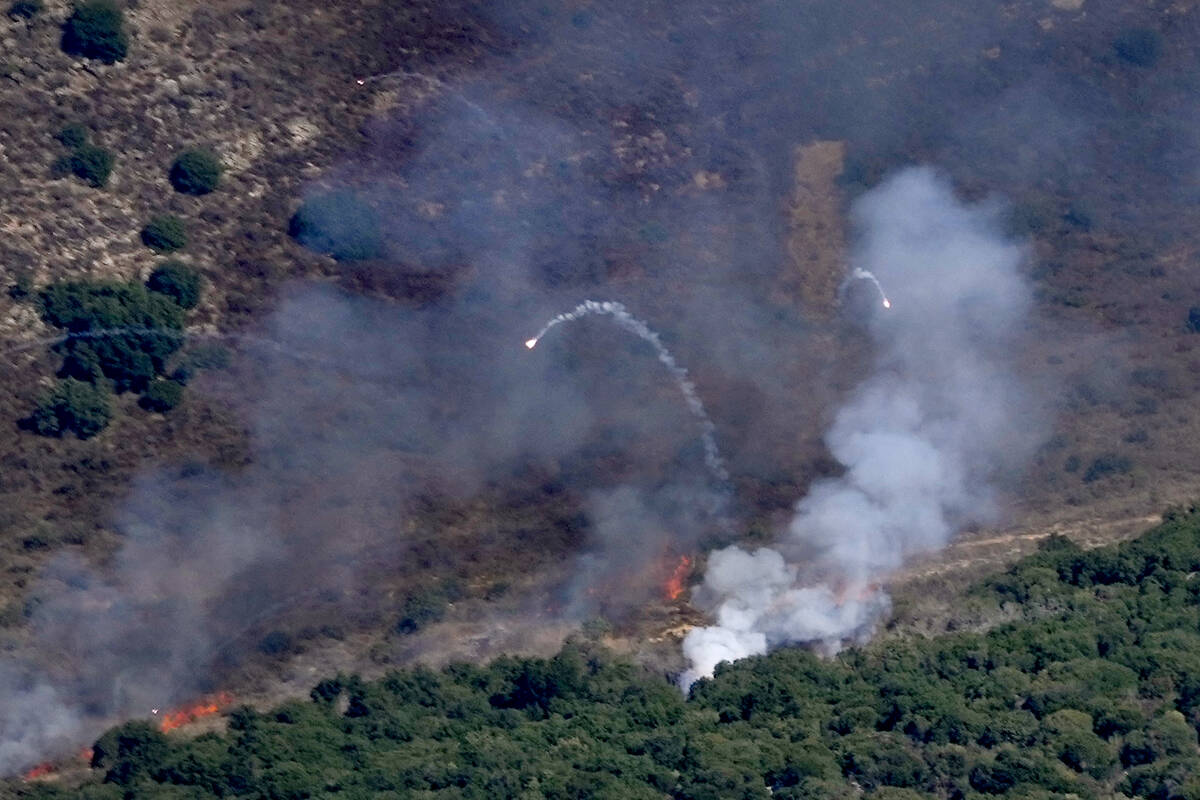 Flames and smoke rise from an Israeli airstrike on Mahmoudieh mountain, as seen from Marjayoun ...