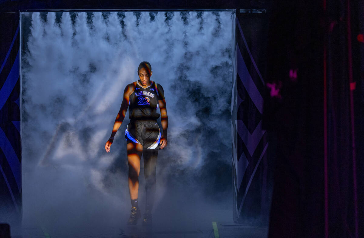 Aces center A'ja Wilson (22) walks through the smoke onto the court while introduced for the fi ...