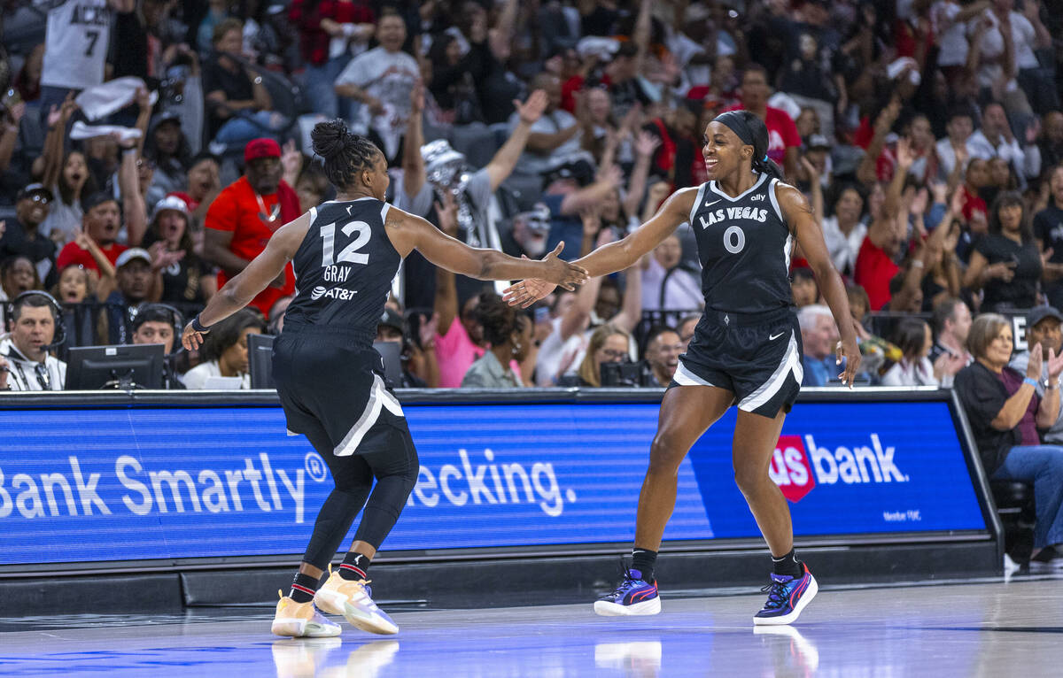 Aces guard Chelsea Gray (12) and guard Jackie Young (0) celebrate their run during the first ha ...