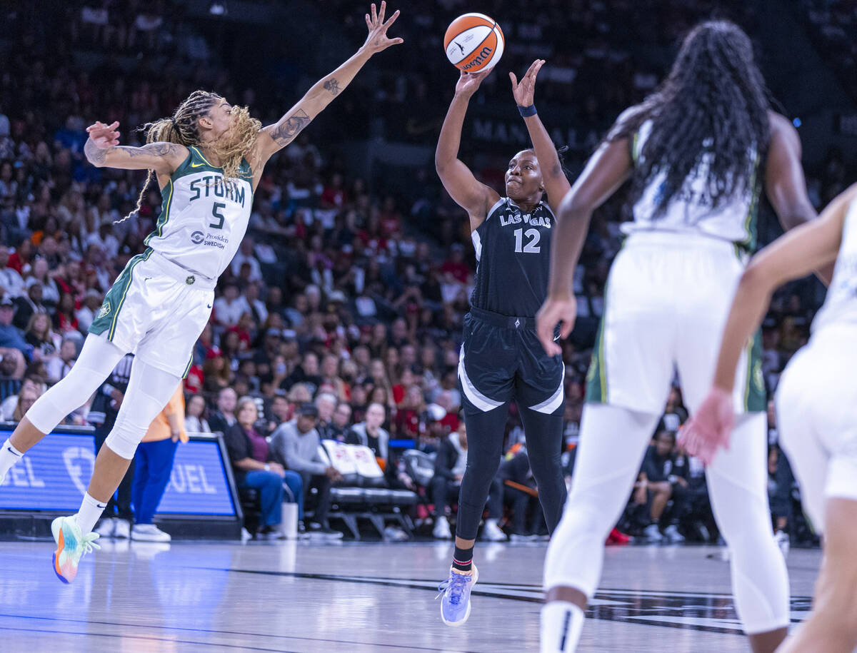 Aces guard Chelsea Gray (12) looks to shoot over Seattle Storm forward Gabby Williams (5) durin ...