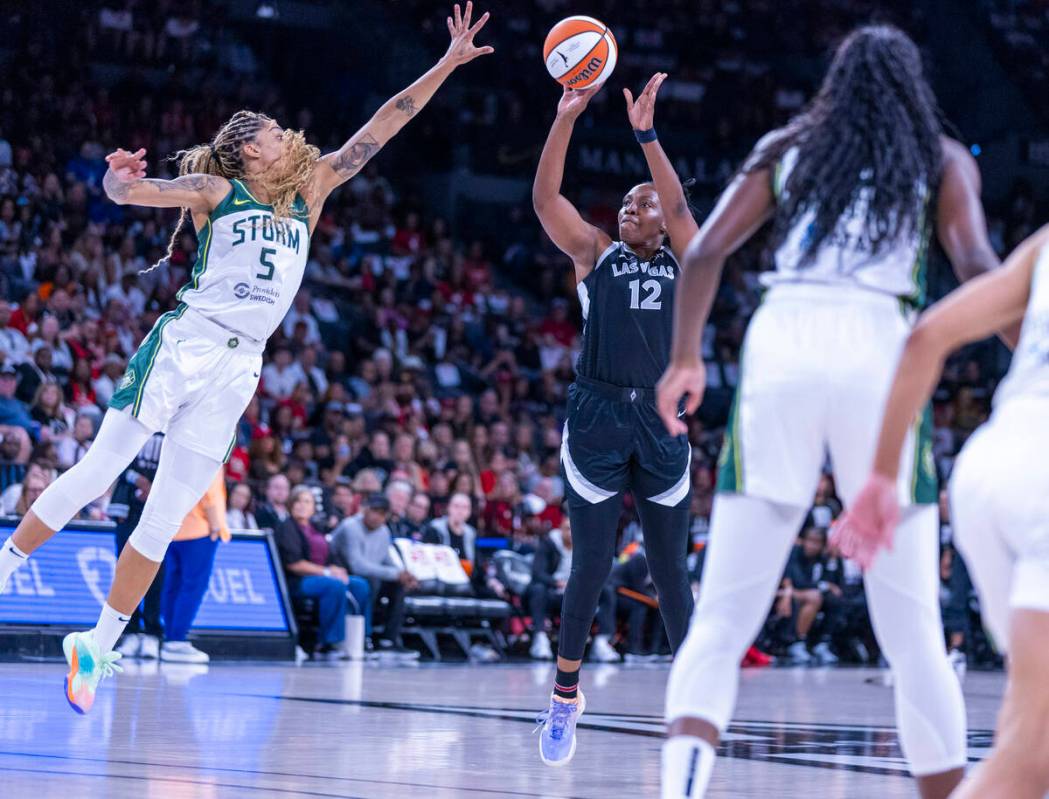 Aces guard Chelsea Gray (12) looks to shoot over Seattle Storm forward Gabby Williams (5) durin ...